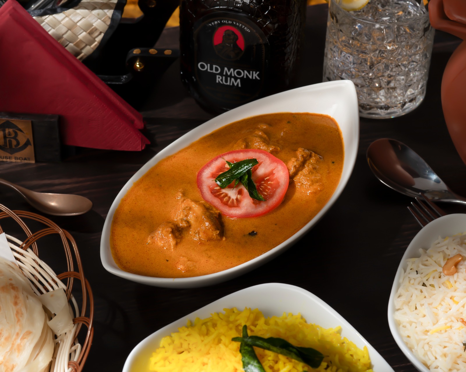 Group sharing platter of curries, tandoori and rice